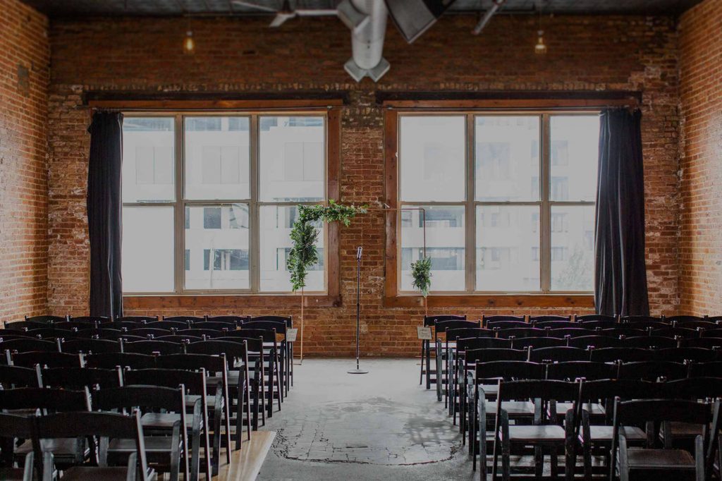 Chairs set in rows for a wedding ceremony in the upstairs space at Bottom Lounge