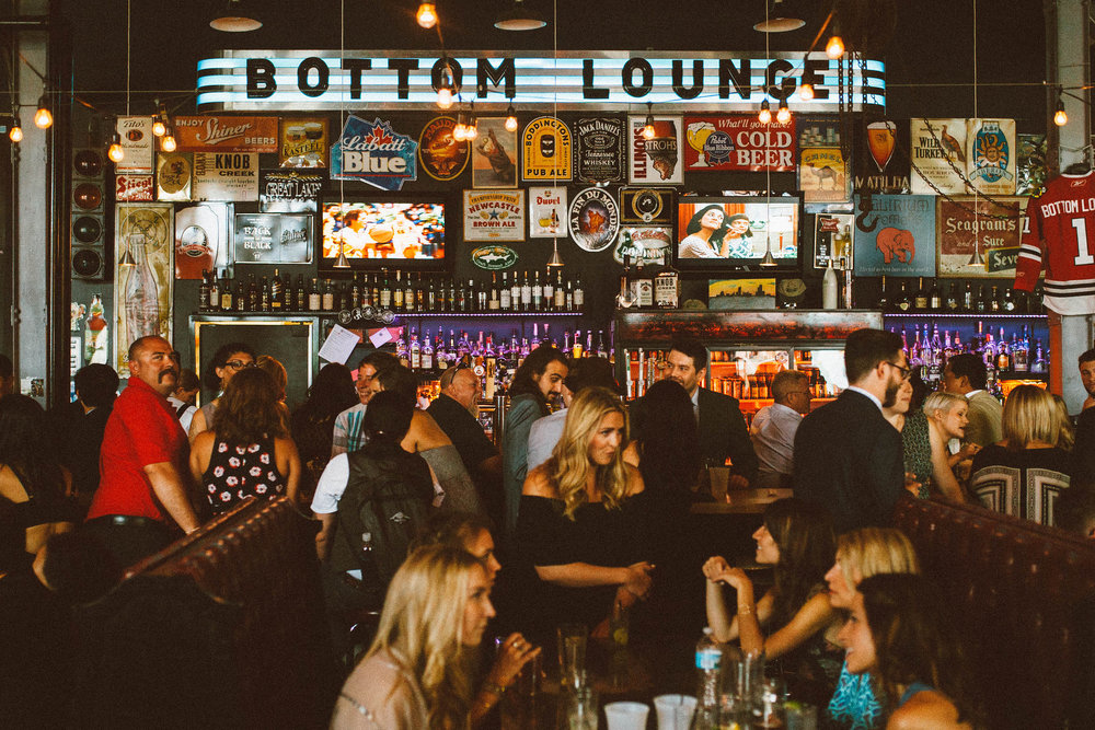 A crowd at the Bottom Lounge bar beneath its neon sign